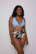 Ozero Swimwear sustainable bikini top in sky blue on a dark-skin model, front, Kuala Lumpur, Malaysia