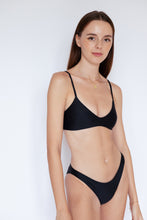 Model wearing Como sustainable Bikini Bottom in Black by Ozero Swimwear, close-up view, designed in Malaysia.