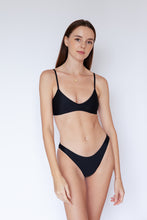 Model wearing Como sustainable Bikini Bottom in Black by Ozero Swimwear, front view, designed in Malaysia.