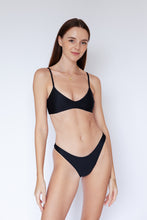 Model wearing Malawi sustainable Bikini Top in Black by Ozero Swimwear, front view, designed in Malaysia.