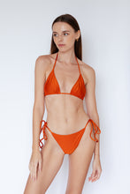 Model wearing Sinclair Bikini Top in Shimmer Burnt Orange by Ozero Swimwear, front view, designed in Malaysia.
